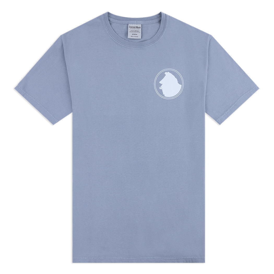 Blueish grey t-shirt with a white Reveille logo on the left side. 