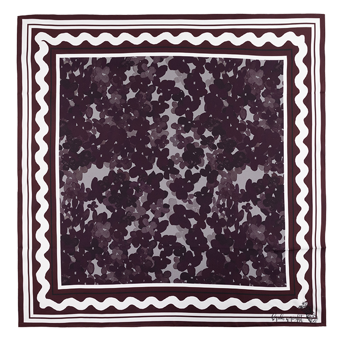 A square scarf. The outer pattern is black and grey checkered print. The next pattern is a solid maroon line followed by two white lines. There is a squiggly white line followed by the center square which is composed of different colored maroon flowers. 