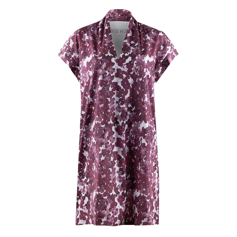 A short sleeve dress with a v-neck style neckline. The pattern is made up of different colored maroon flowers with a white background. 