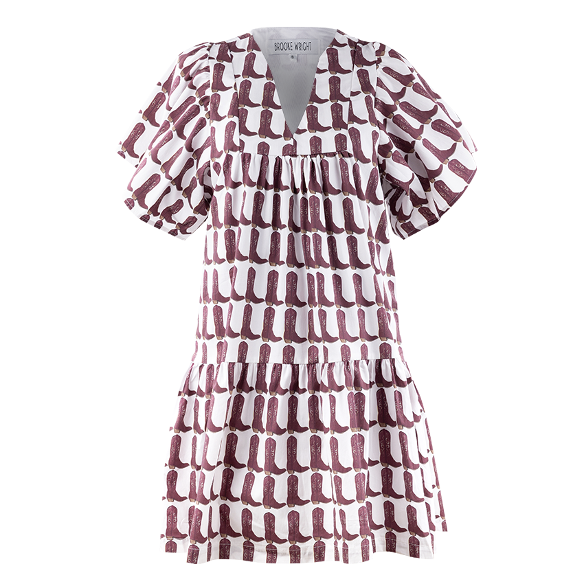 A loose short sleeve dress. It has a maroon cowgirl boot style design and the background color is white. It has a v-neck style neckline. 