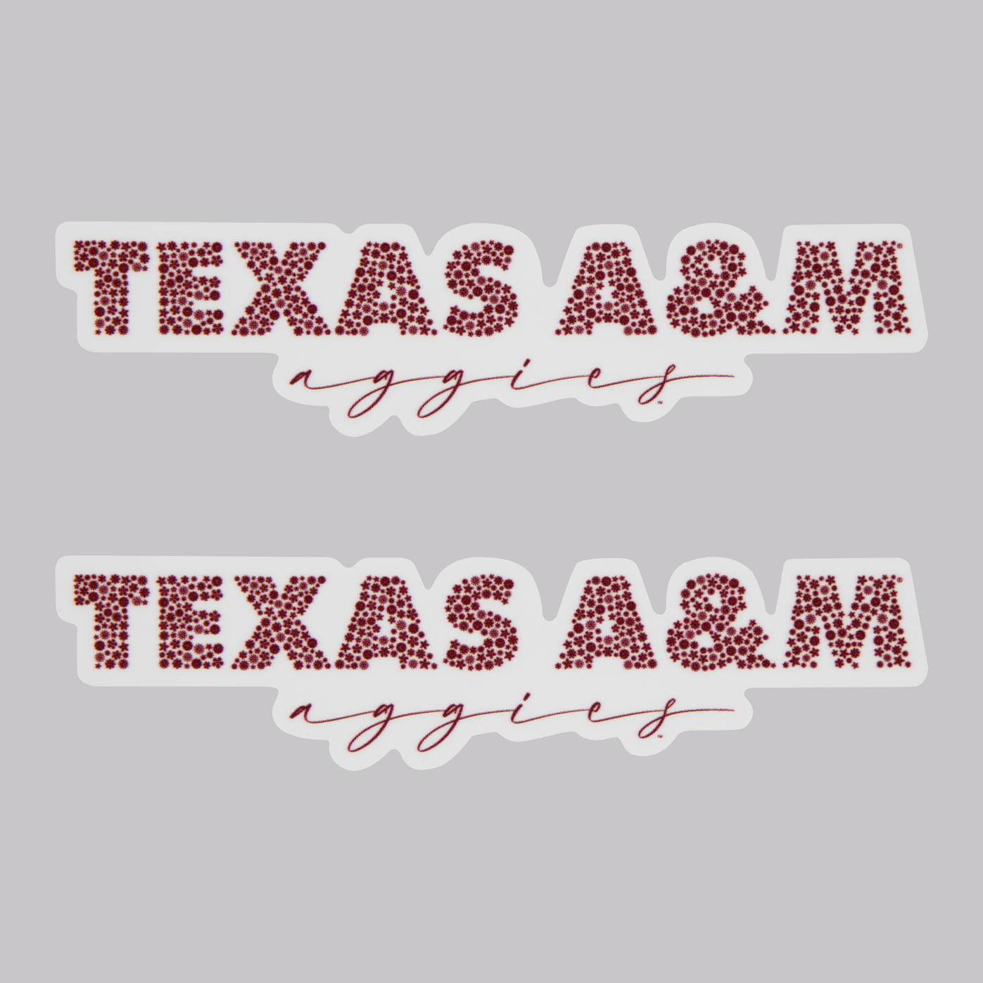 Stickers. 'texas a&m' is printed in a firework like pattern. under this is 'aggies' printed in maroon. 