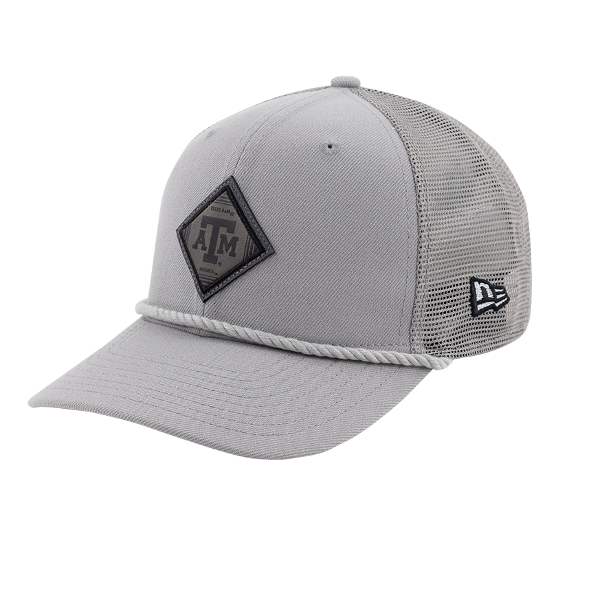 A light grey hat with a light grey mesh back. There is a light grey rope stretching across the front. There is a dark grey diamond shaped logo patch with A&M in the center located on the front of the hat. 