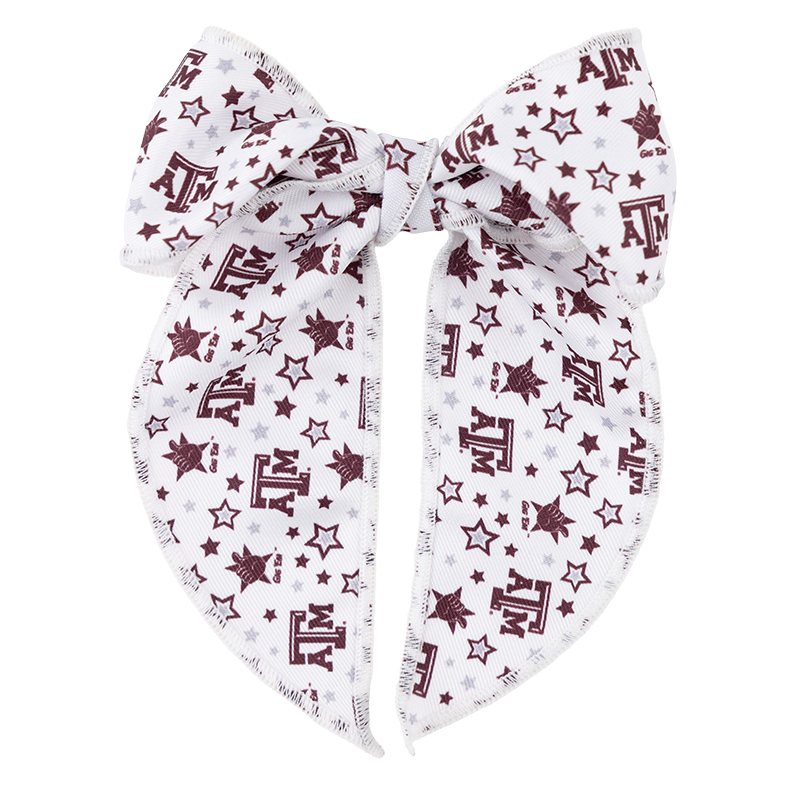 A white bow with A&M maroon symbols printed throughout. There are also maroon and grey stars printed throughout the bow. 