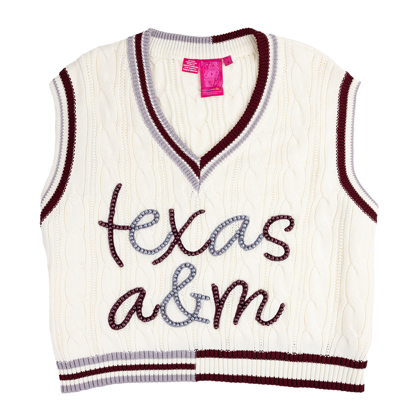 White sweater vest with maroon and gray trim at the collar, sleeves, and bottom of the vest. "Texas A&M" is on the front in maroon and gray pearls.