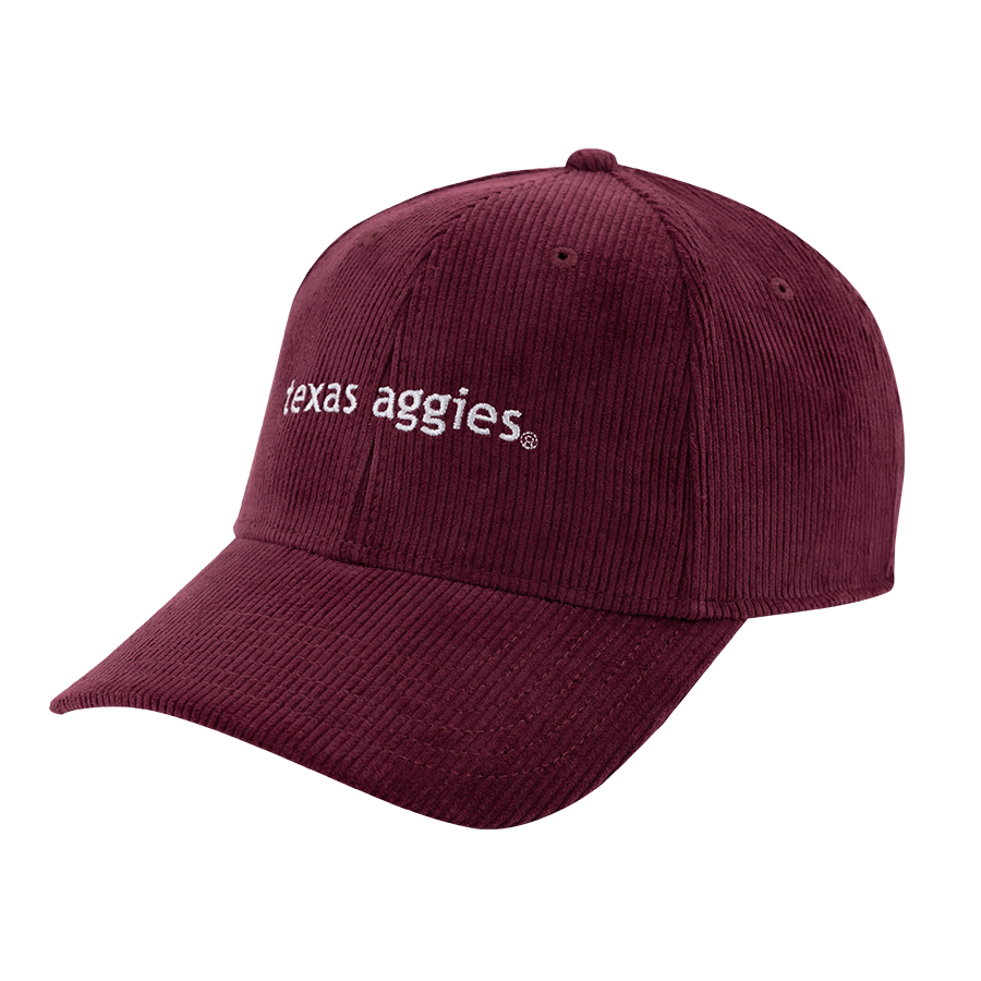 A maroon corduroy hat with 'texas aggies' written in white script letters 